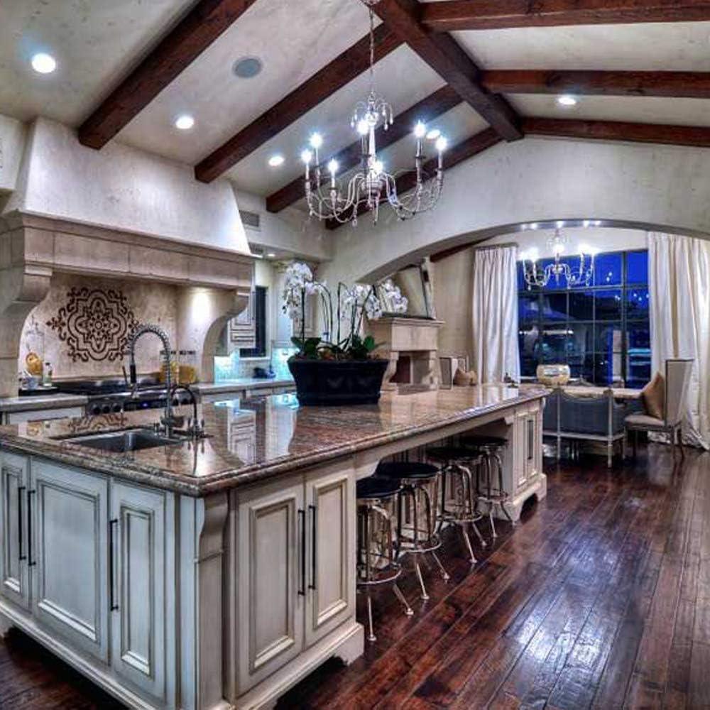 Elegant kitchen with LED ceiling lights, chandeliers, and wooden beams over marble island
