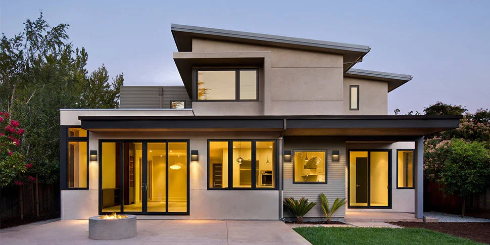 Modern home exterior at dusk with energy-efficient LED outdoor wall lighting.